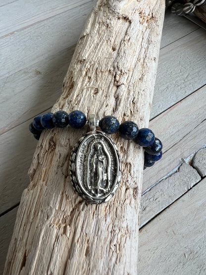 Faceted lapis beads surround a beautiful Tibetan repousé Mary. Stretch stacker bracelet 6-6.5”