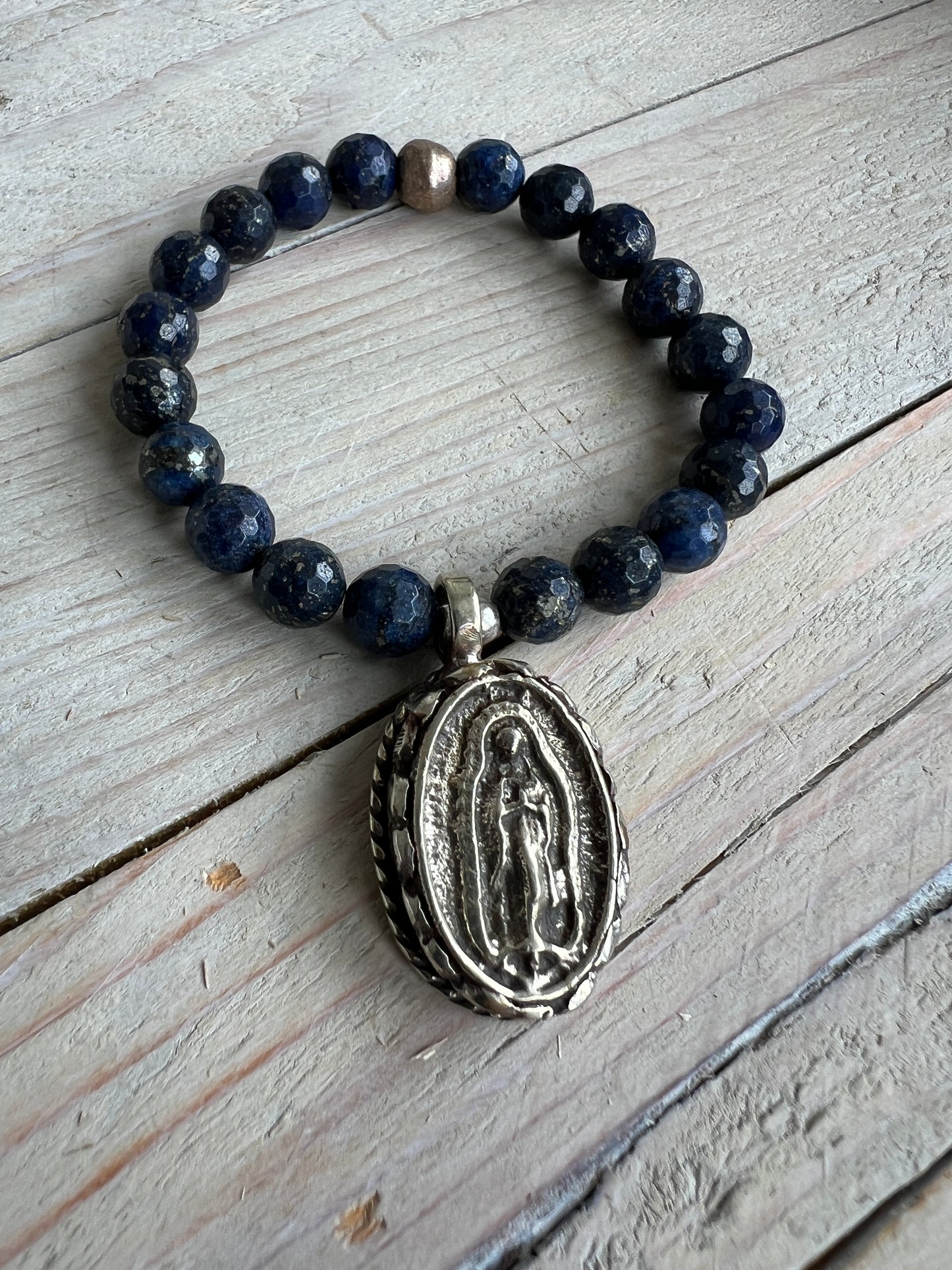 Faceted lapis beads surround a beautiful Tibetan repousé Mary. Stretch stacker bracelet 6-6.5”