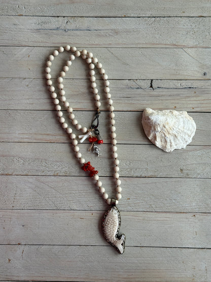 Tibetan carved bone fish on knotted riverstone and coral long necklace. Coral and fine silver fish charms.