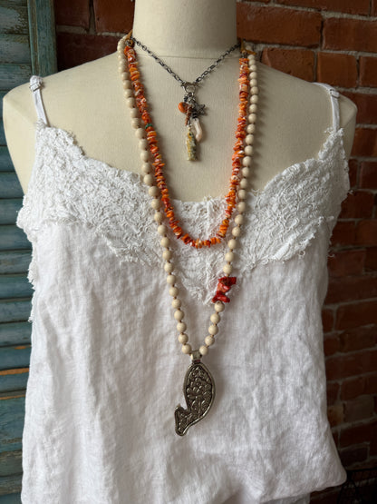 Tibetan carved bone fish on knotted riverstone and coral long necklace. Coral and fine silver fish charms.