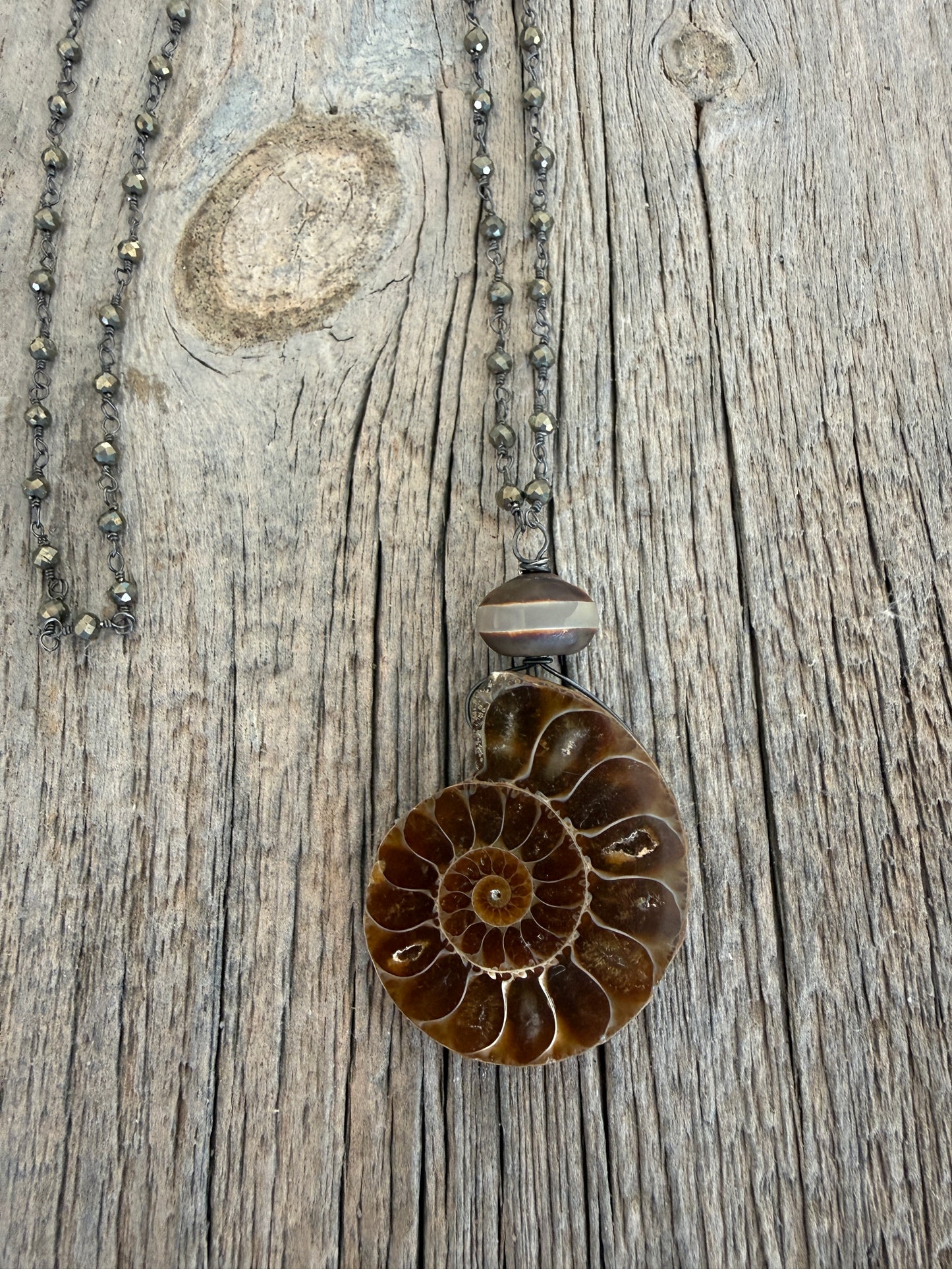 Natural ammonite fossil on pyrite chain necklace.