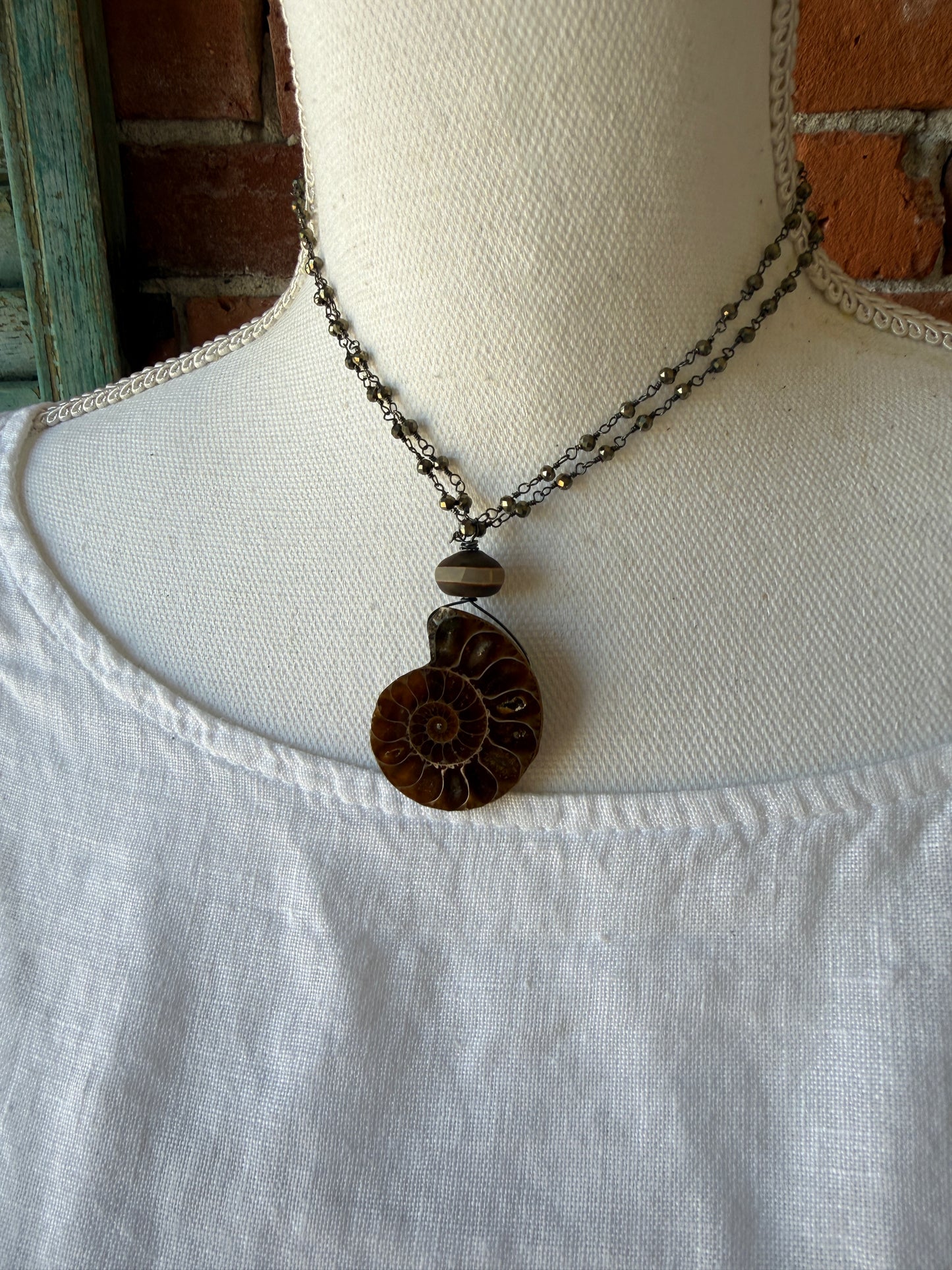 Natural ammonite fossil on pyrite chain necklace.