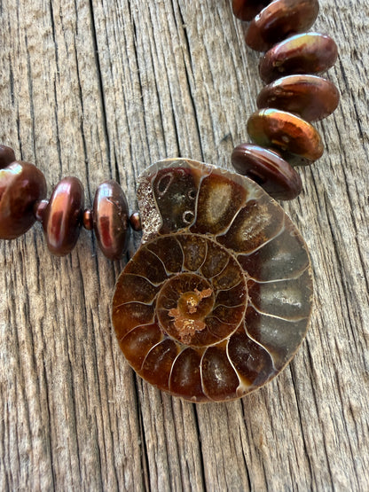 A natural ammonite fossil and chocolate brown button pearl necklace.