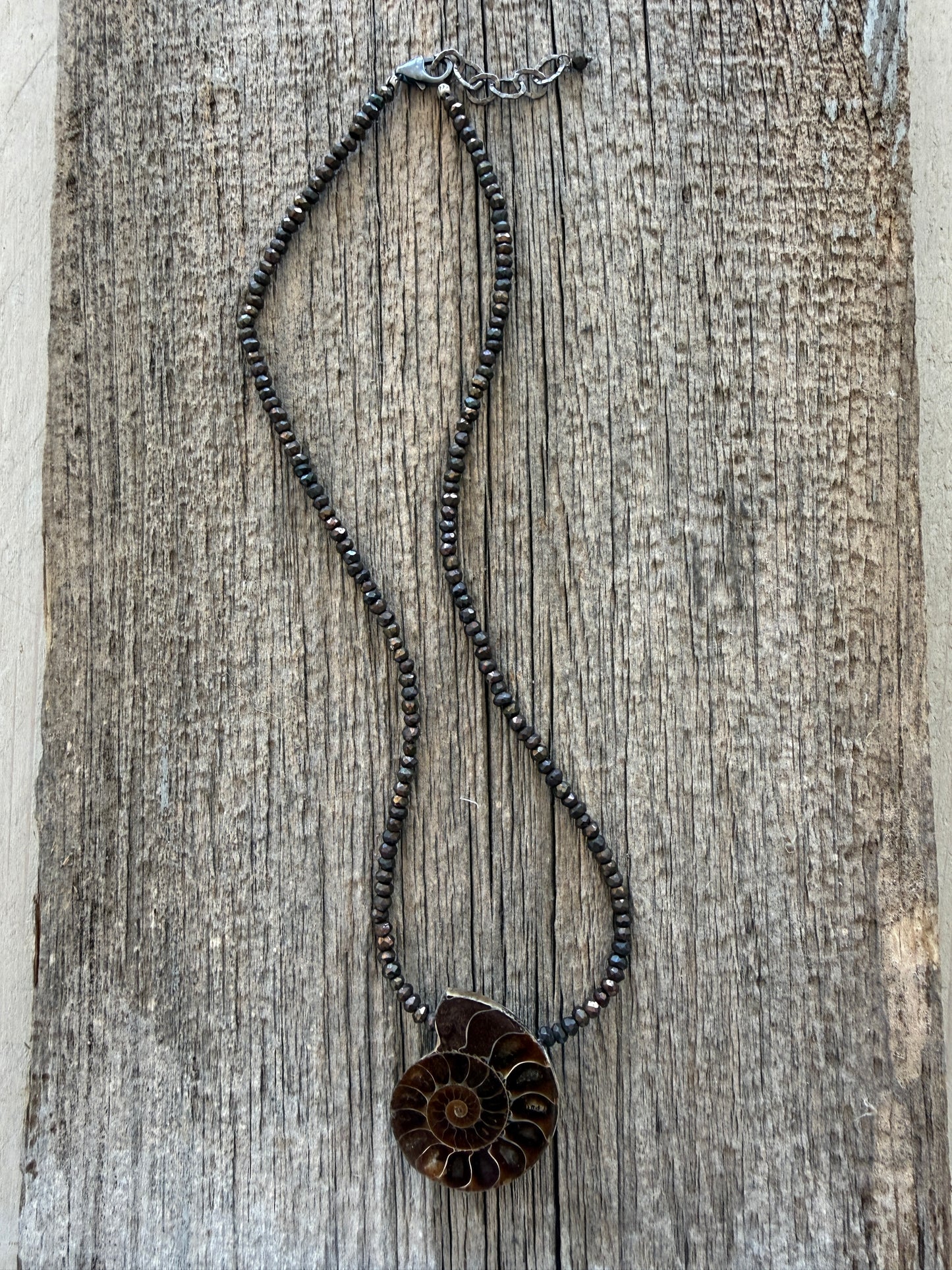 Ammonite fossil on chocolate pyrite necklace. 17.5-19”