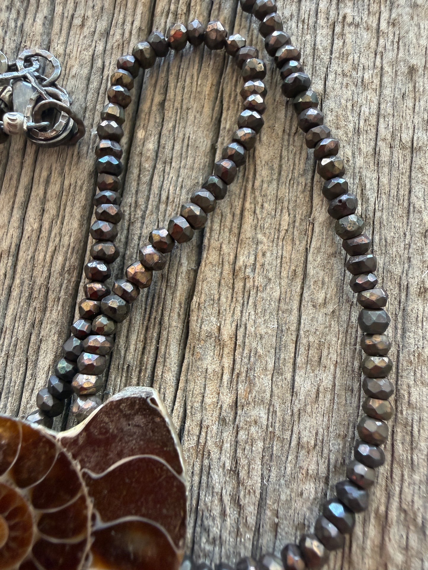 Ammonite fossil on chocolate pyrite necklace. 17.5-19”