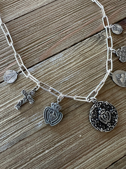 Aged sterling silver heart, cross, and saints medals on paperclip chain, sterling silver necklace. Adjustable to 18.5”.