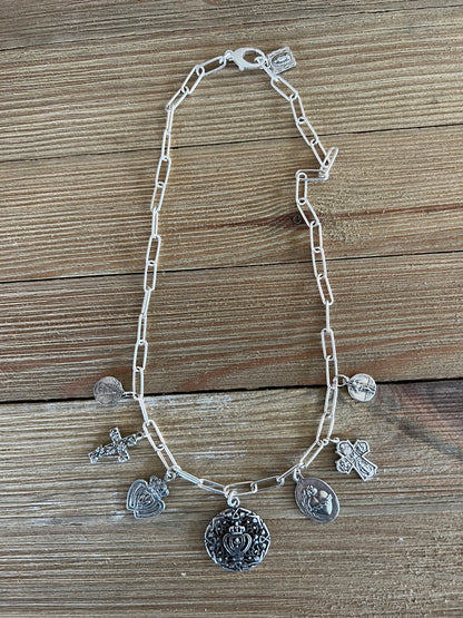 Aged sterling silver heart, cross, and saints medals on paperclip chain, sterling silver necklace. Adjustable to 18.5”.