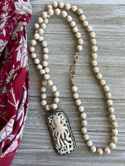 Exquisite carved bone octopus on hand-knotted matte riverstone beads..  39” necklace. Wear long or short.