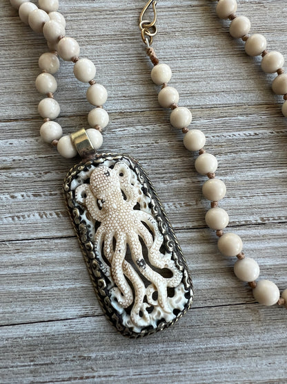 Exquisite carved bone octopus on hand-knotted matte riverstone beads..  39” necklace. Wear long or short.