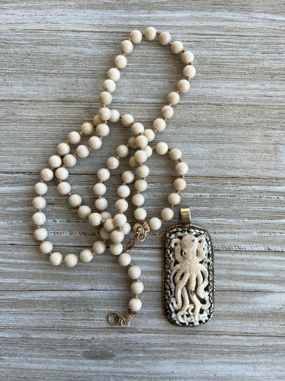 Exquisite carved bone octopus on hand-knotted matte riverstone beads..  39” necklace. Wear long or short.