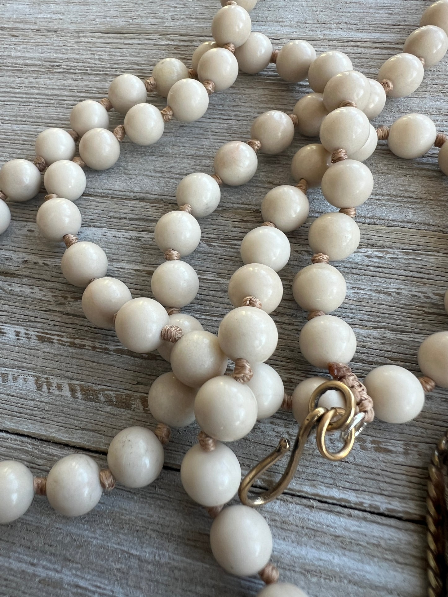 Exquisite carved bone octopus on hand-knotted matte riverstone beads..  39” necklace. Wear long or short.