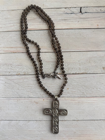 Blue kyanite cross on knotted smoky quartz necklace with fine silver flower accents.