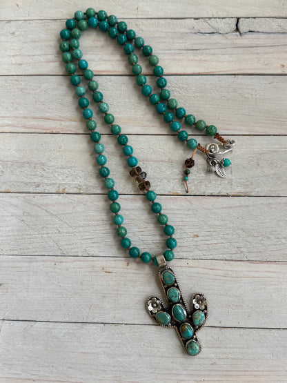 Turquoise cactus pendant necklace on knotted turquoise with smoky quartz and fine silver accents.