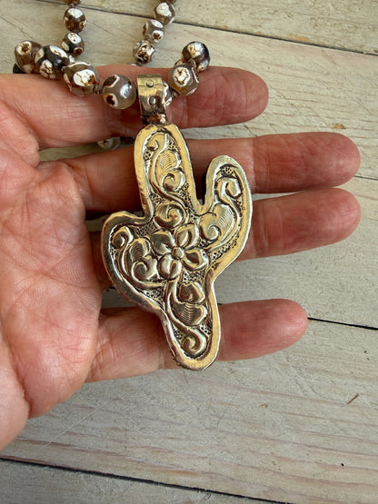 Bone cactus pendant on Dzi agates with fine silver embellishments. 34.5”