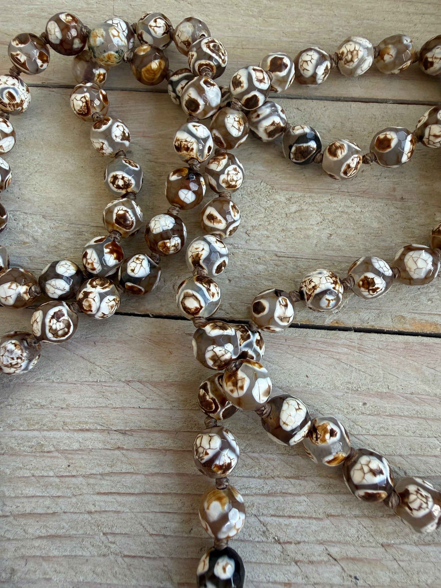 Bone cactus pendant on Dzi agates with fine silver embellishments. 34.5”