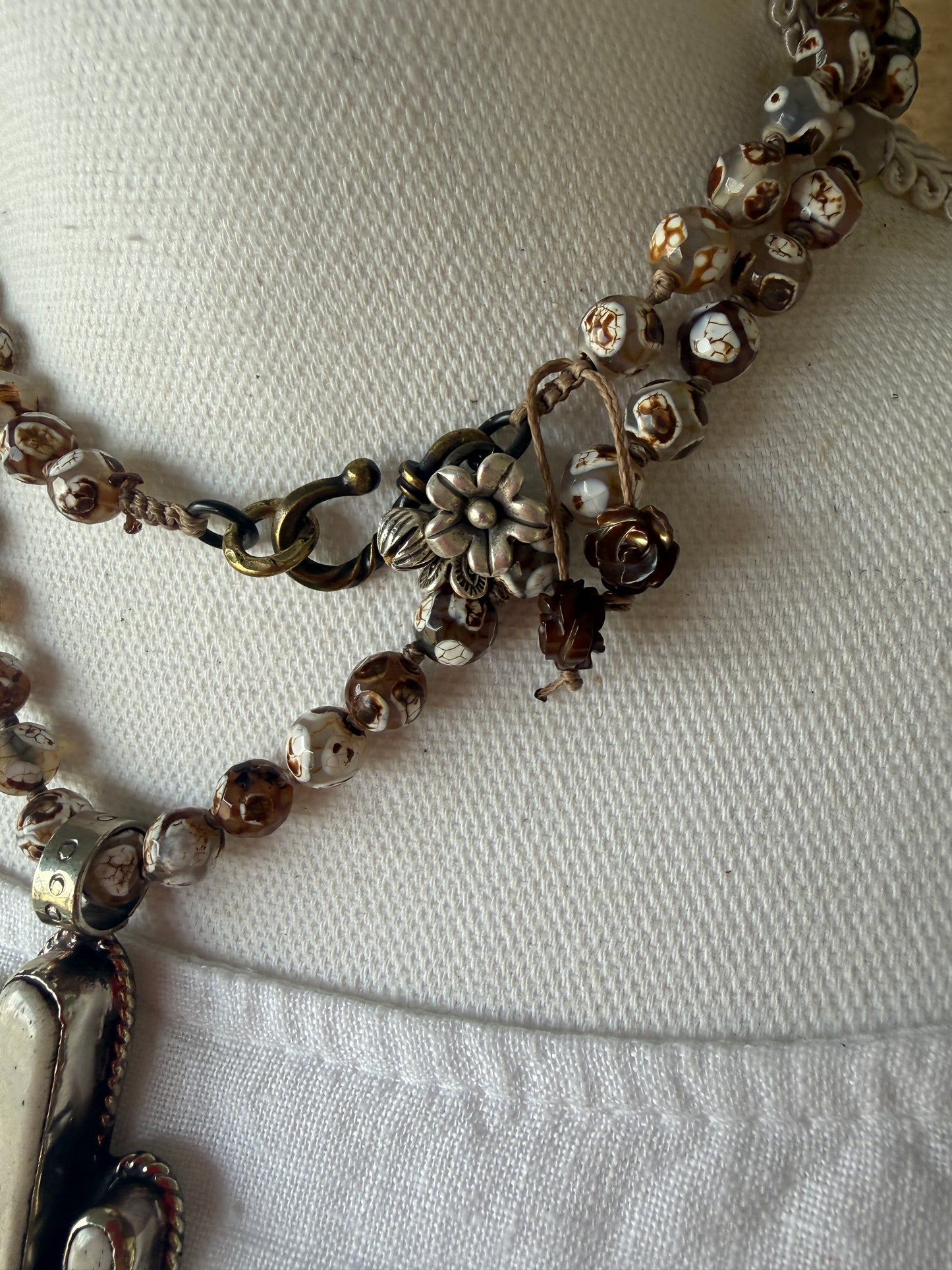 Bone cactus pendant on Dzi agates with fine silver embellishments. 34.5”