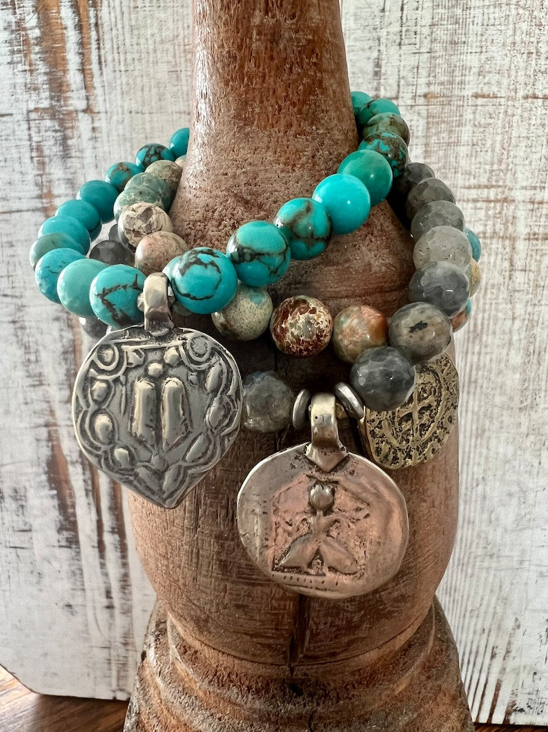 Lotus feet. Artisan made charm suspended on turquoise rounds stretch boho yogi bracelet. 7”