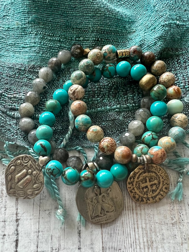 Lotus feet. Artisan made charm suspended on turquoise rounds stretch boho yogi bracelet. 7”