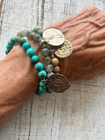 Lotus feet. Artisan made charm suspended on turquoise rounds stretch boho yogi bracelet. 7”