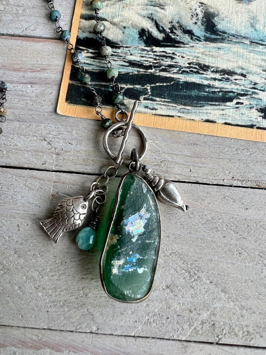 Ancient Roman glass with a beach vibe on tiny faceted turquoise chain. Fine silver shell, fish and stamped toggle.