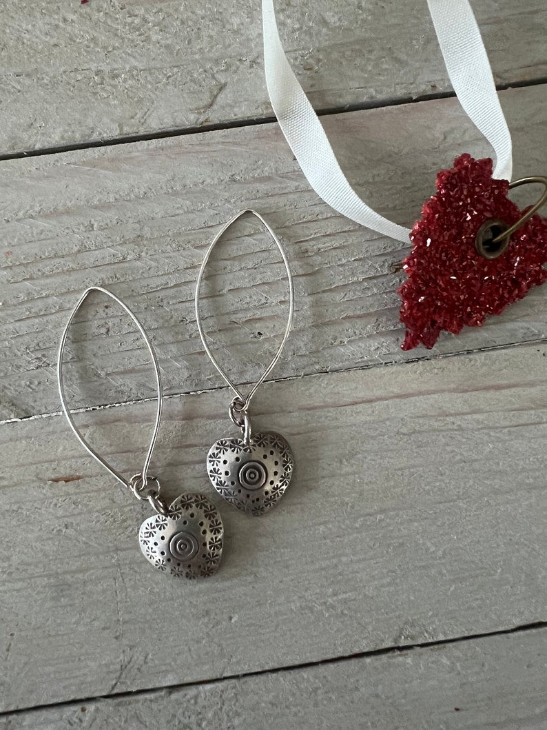 Fine silver stamped heart earrings on ellipse-shaped sterling ear wire. Sister, wife, daughter, gf gift. 2.25” long. Valentines Day gift.