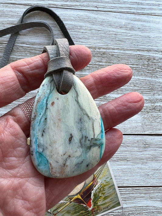 Turquoise pendant on grey deerskin leather with adjustable slider.