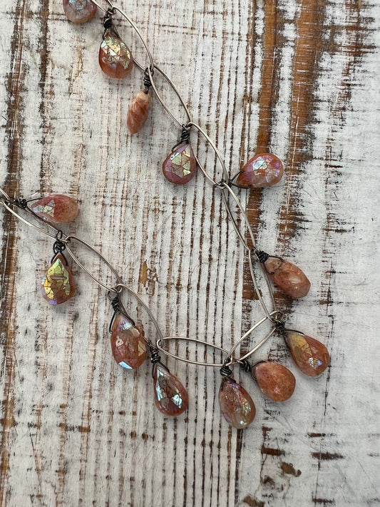 Sunstone teardrops sway from a sterling chain necklace