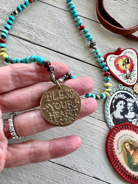 Bless Your Heart artisan made pendant hand-knotted turquoise, pyrite, garnets, broom coral, and serpentine. Adjustable deerskin back.