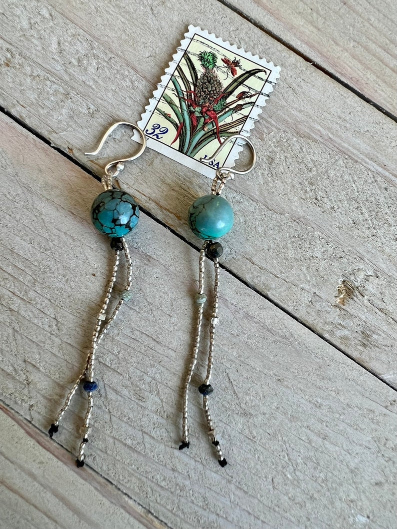 Turquoise with fine silver, pyrite, and lapis dangle earrings on fine silver ear wires. 3” long dangle earrings. Lightweight.