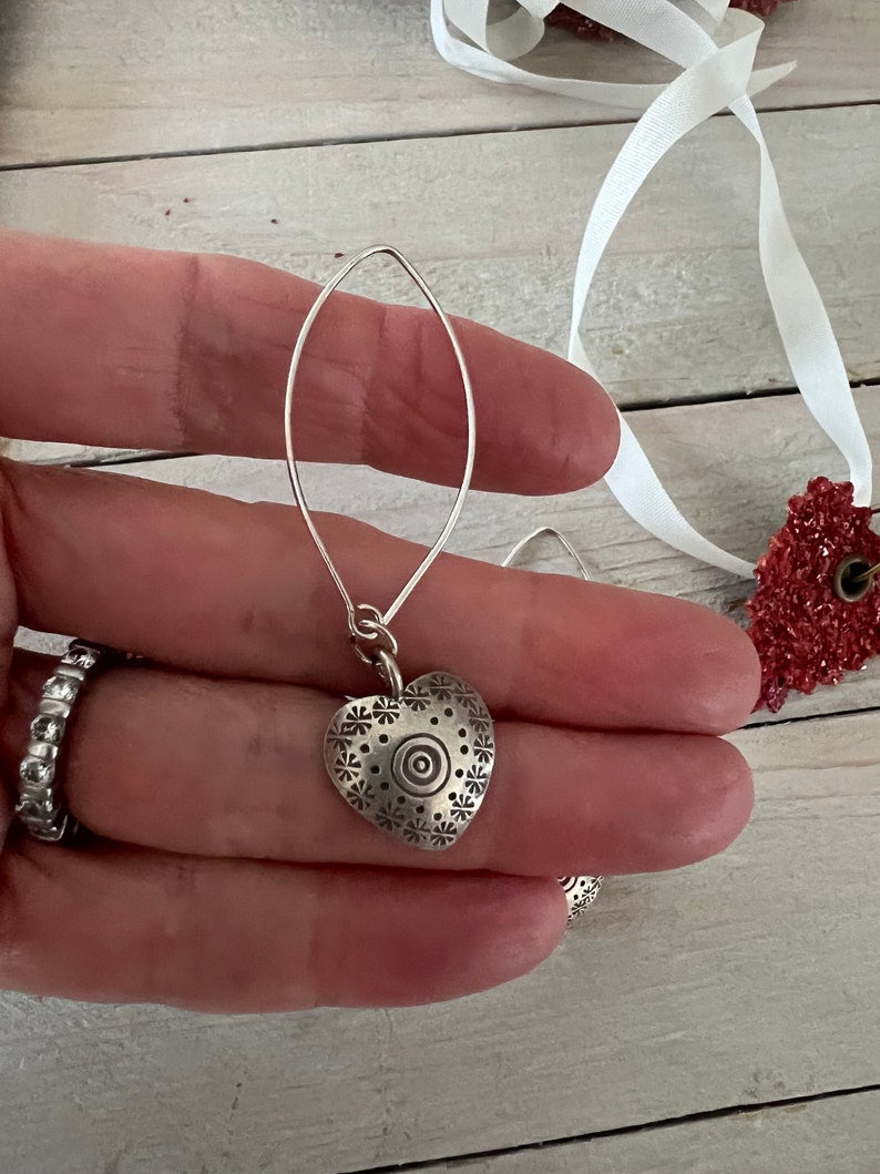 Fine silver stamped heart earrings on ellipse-shaped sterling ear wire. Sister, wife, daughter, gf gift. 2.25” long. Valentines Day gift.