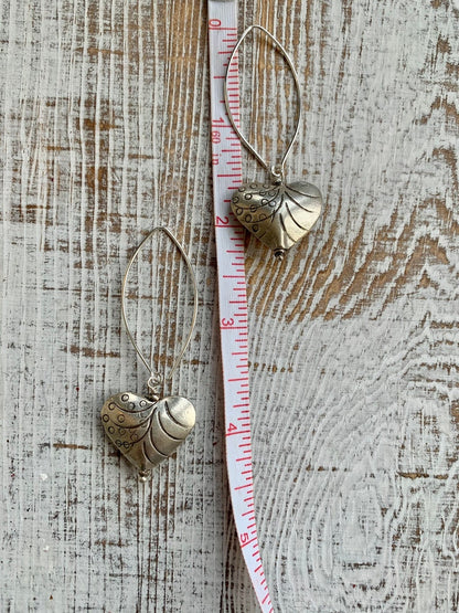 Fine silver stamped heart earrings on ellipse-shaped sterling ear wire. Sister, wife, daughter, gf gift