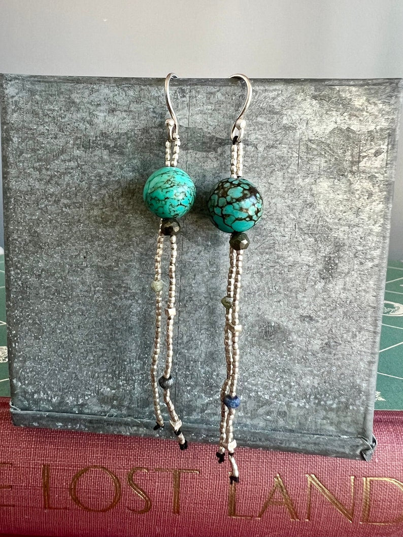 Turquoise with fine silver, pyrite, and lapis dangle earrings on fine silver ear wires. 3” long dangle earrings. Lightweight.