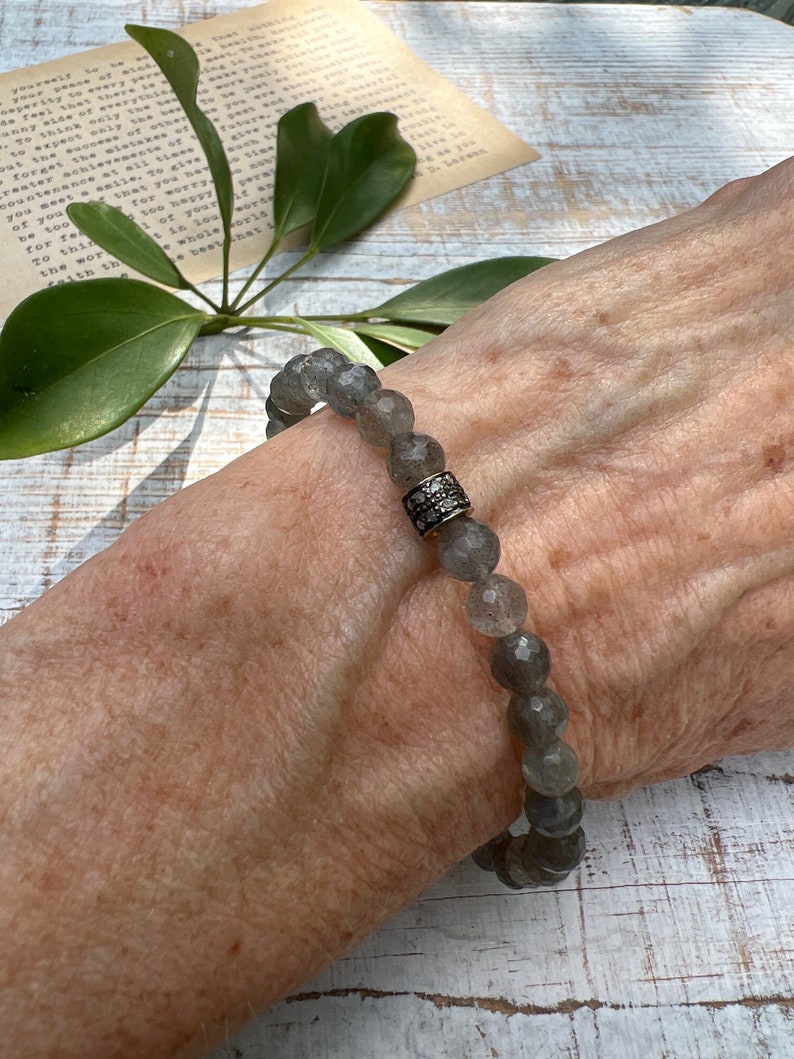 Faceted Labradorite beads surround a pavé diamond bead. Handmade and OOAK. Stretchy, fits most wrists 7”).