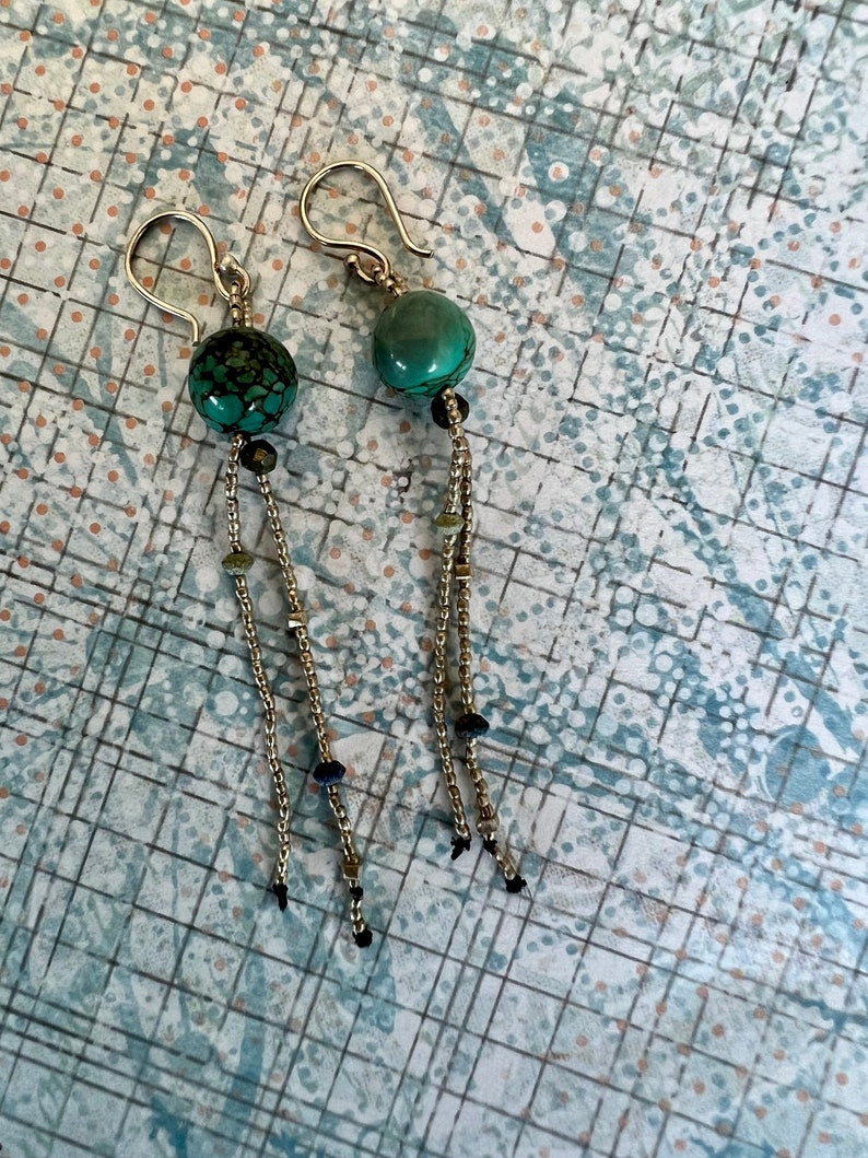 Turquoise with fine silver, pyrite, and lapis dangle earrings on fine silver ear wires. 3” long dangle earrings. Lightweight.