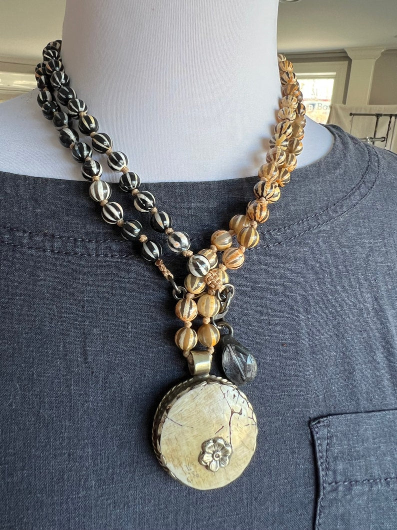 Tibetan bone round pendant knotted with Tibetan agates. Long, earthy boho necklace