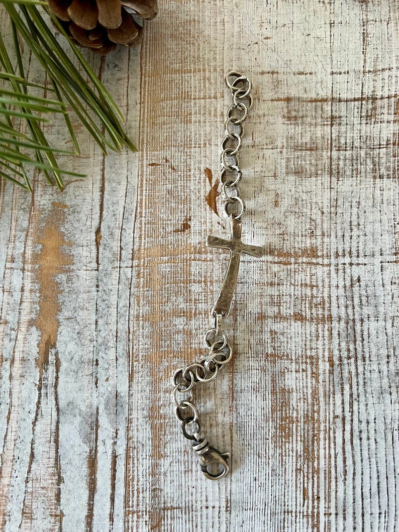 Hammered sterling cross on stamped fine silver chain. Sterling swivel lobster clasp. Great addition to your stack. 7” silver