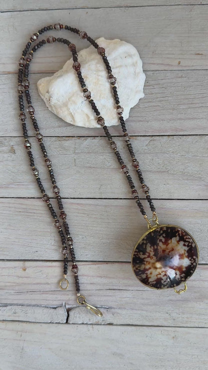 Limpet shell “purse” with chocolate pyrite, pearls, and Czech glass necklace. 
